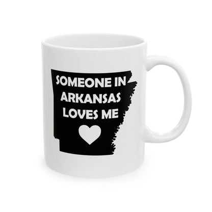 White mug with black text 'Someone in Arkansas loves me' and a heart on a white background