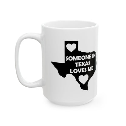 White mug with black text and heart shapes on a white background  with text  Someone In Texas Loves Me