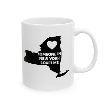 White mug with black silhouette of New York state and heart, text 'Someone in New York loves me' on a white background