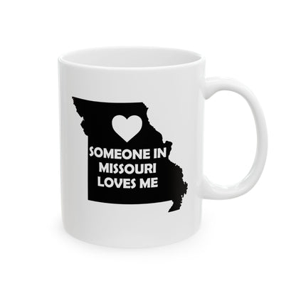 White mug with black silhouette of Missouri and heart, text 'Someone in Missouri loves me' on a white background