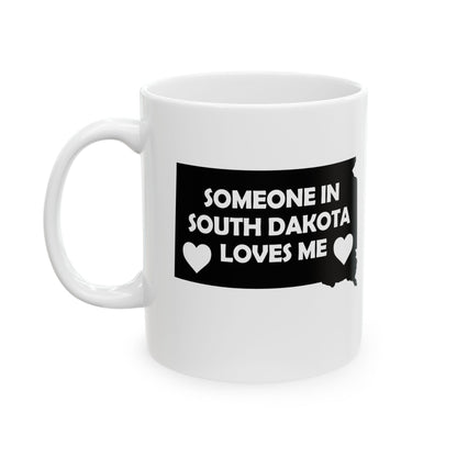 White mug with a black graphic and text 'Someone in South Dakota loves me' on a white background